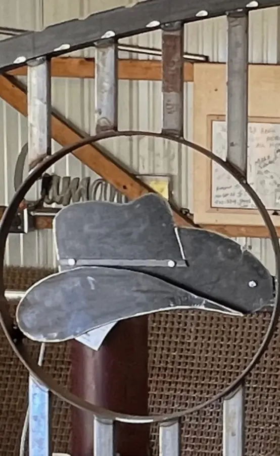 Hand-fabricated cowboy hat medallion in a steel ring at the fabrication shop